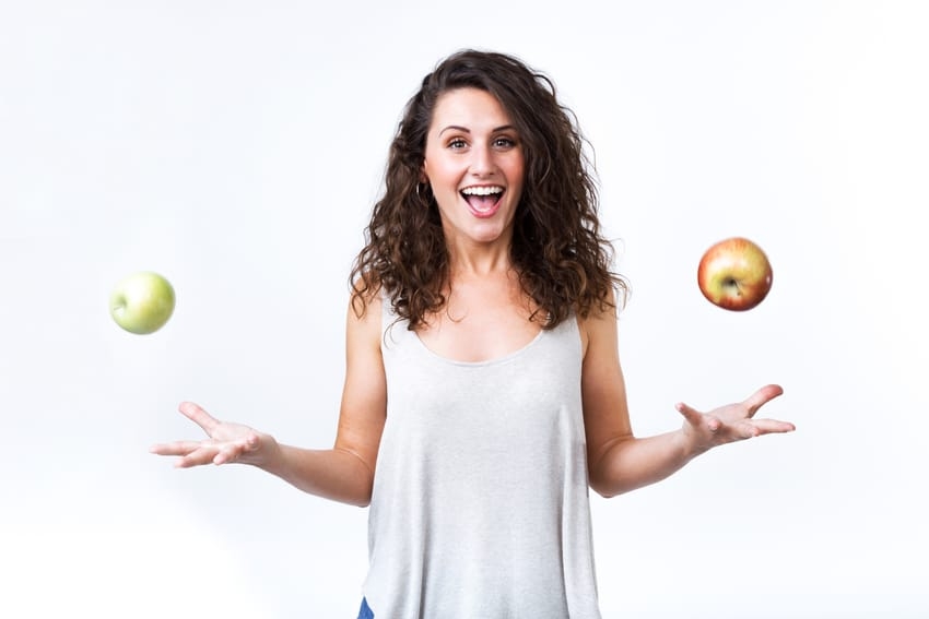 Woman juggling with apples